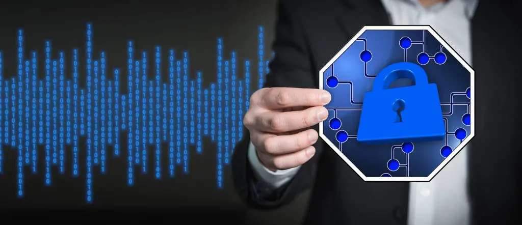 a man in a suit holds up a picture of a blue padlock