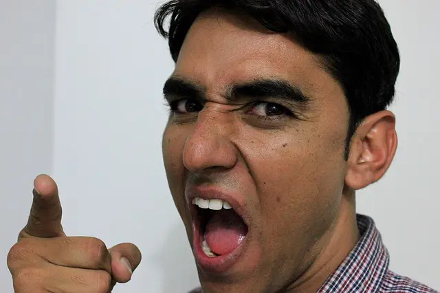 a man is making a funny face and pointing at the camera