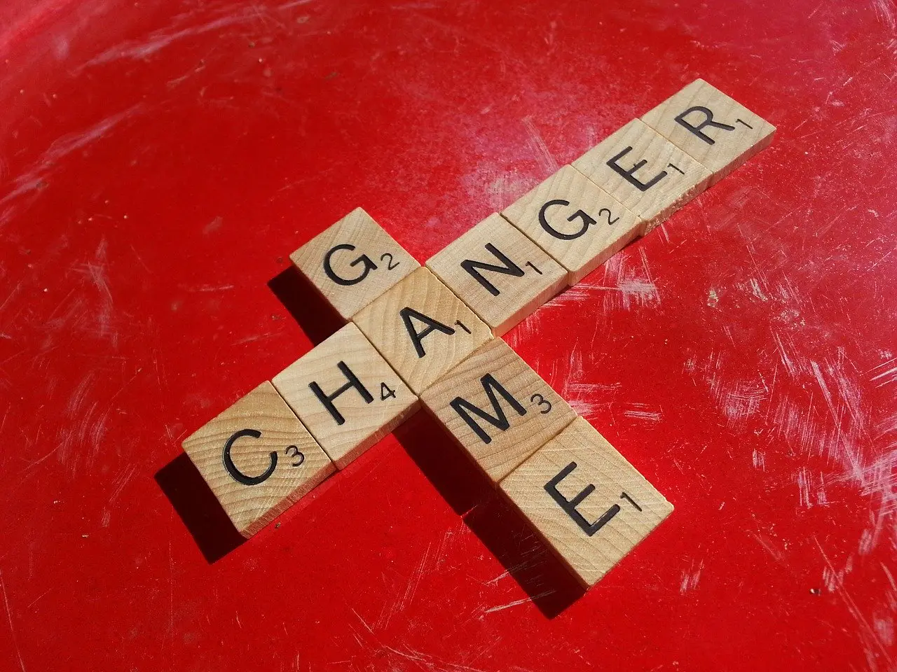 Scrabble blocks with the words "game changer" written on them