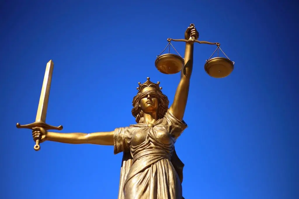 lady justice with a blue sky behind