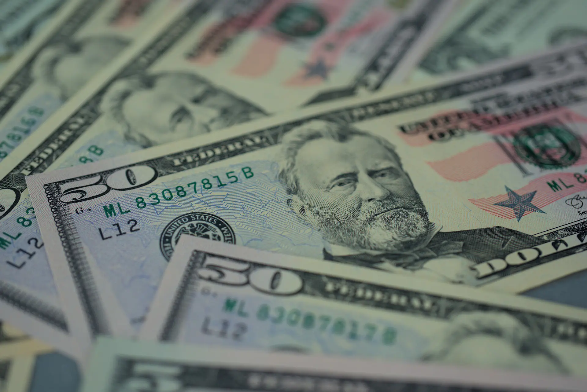 several 50 dollar bills are laying on a table