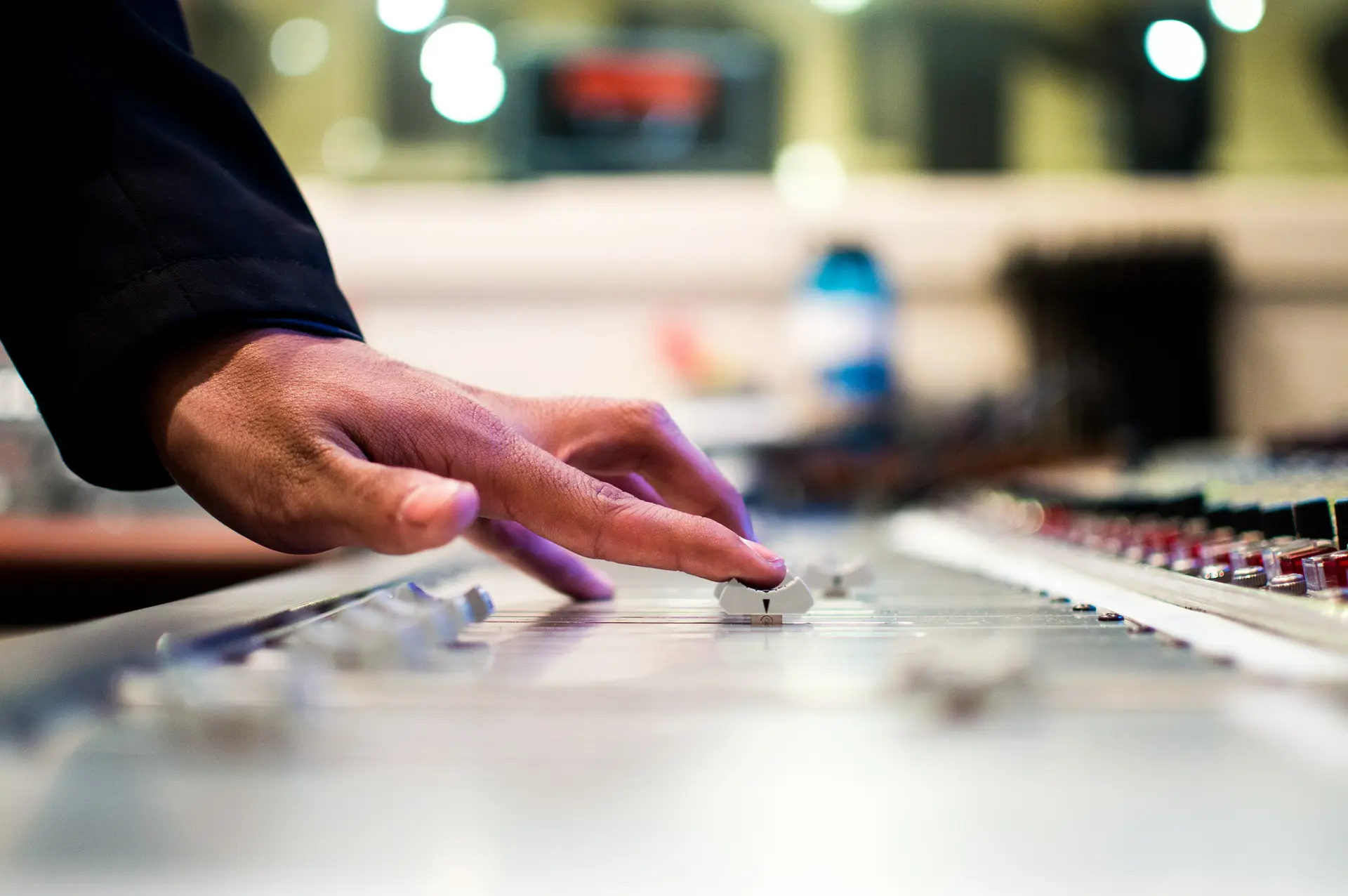 a hand moving a button on a soundboard