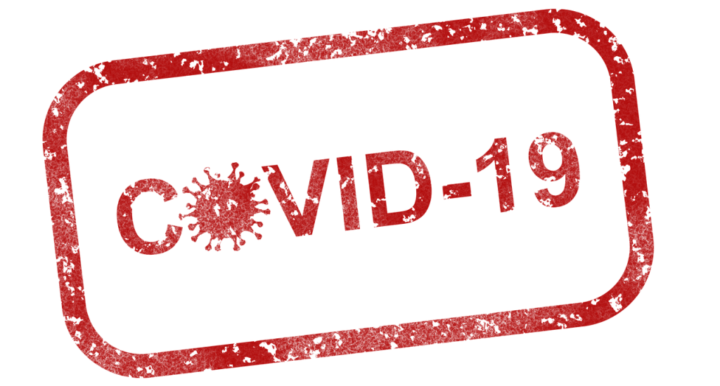 a red covid-19 stamp on a green background