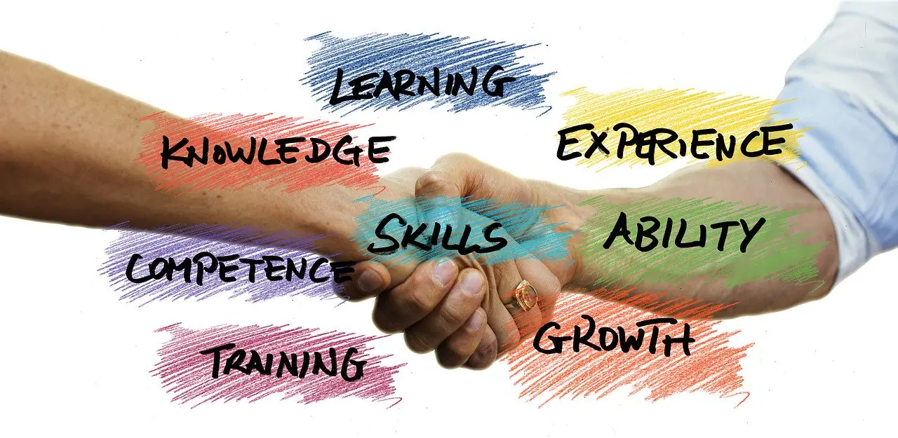 a handshake with the words learning experience skills competence training and growth written on it