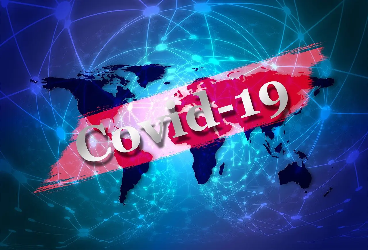 the words 'Covid-19' with a map in the background and glowing lines connected by dots