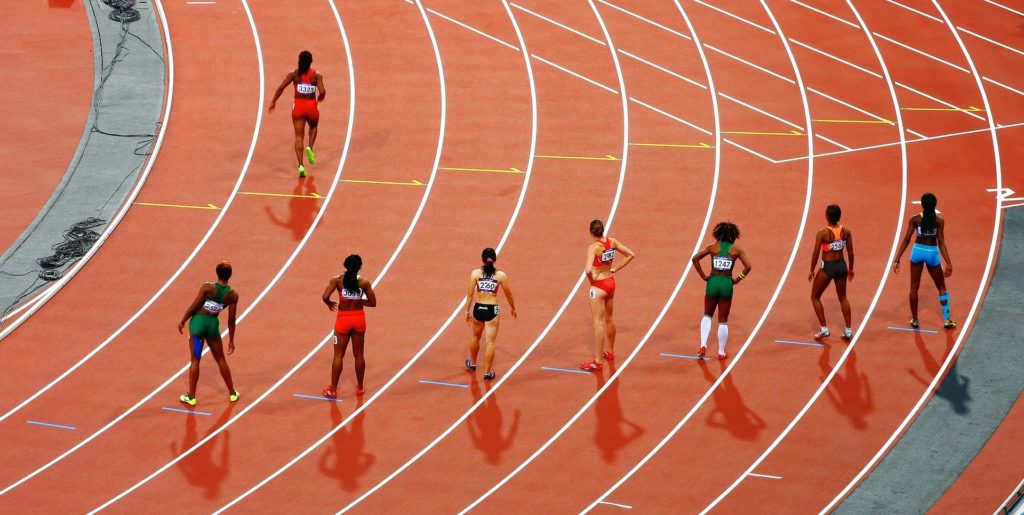 a group of female athletes are lined up on a track