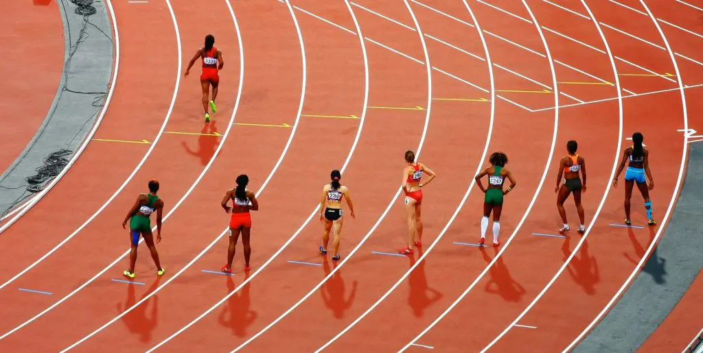 a group of female athletes are lined up on a track