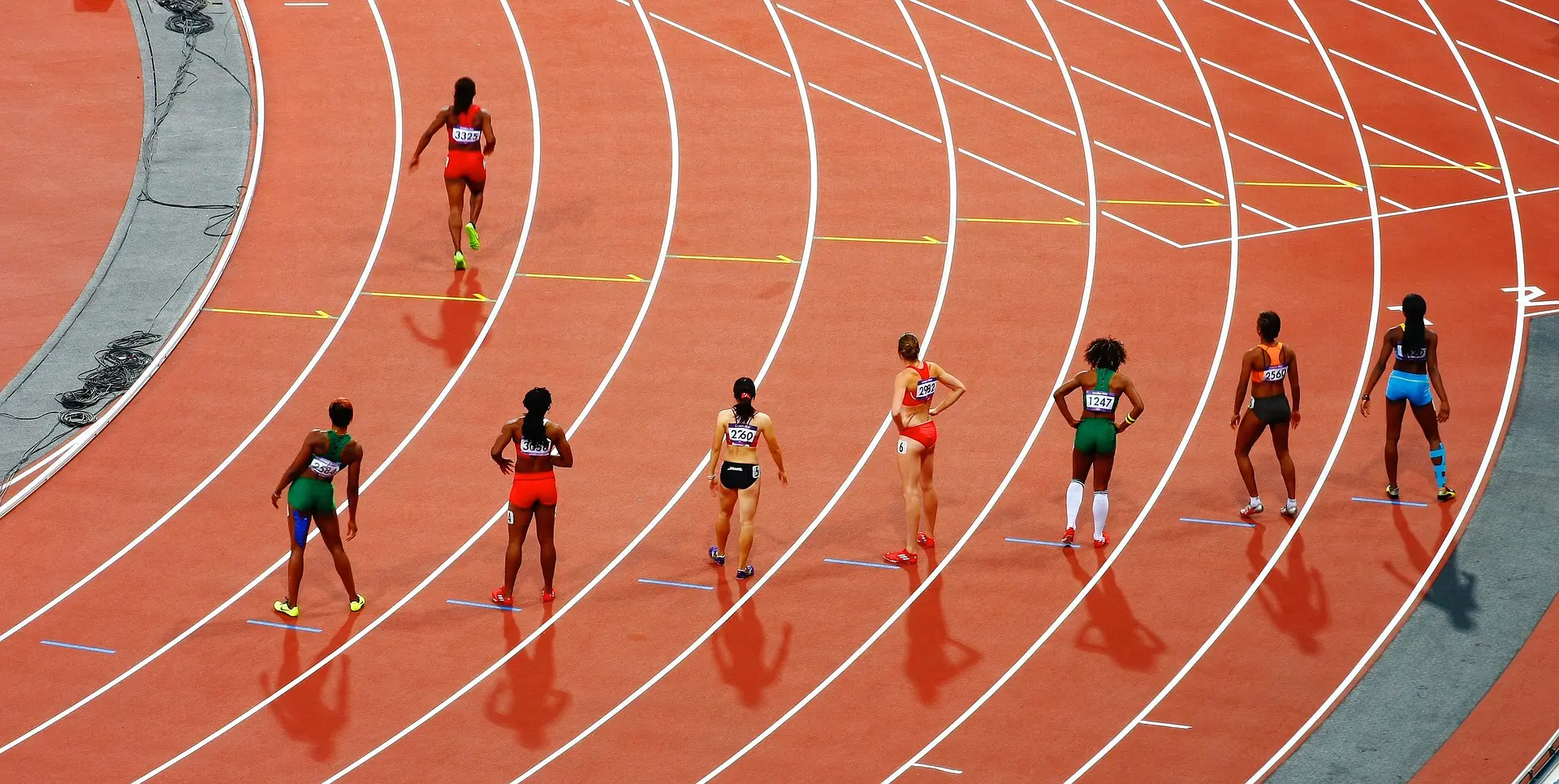a group of female athletes are lined up on a track