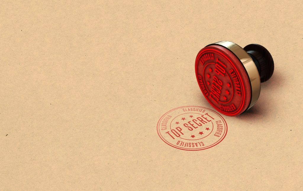 a stamp lying on its side with its design featured on the surfacing it is lying on