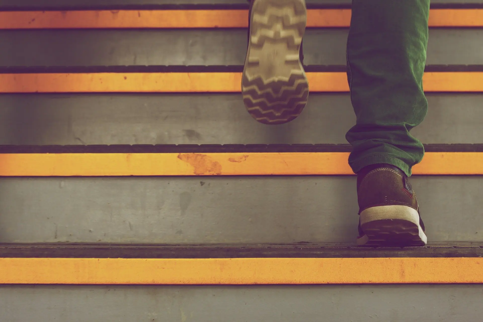 a person 's foot is walking up a set of stairs