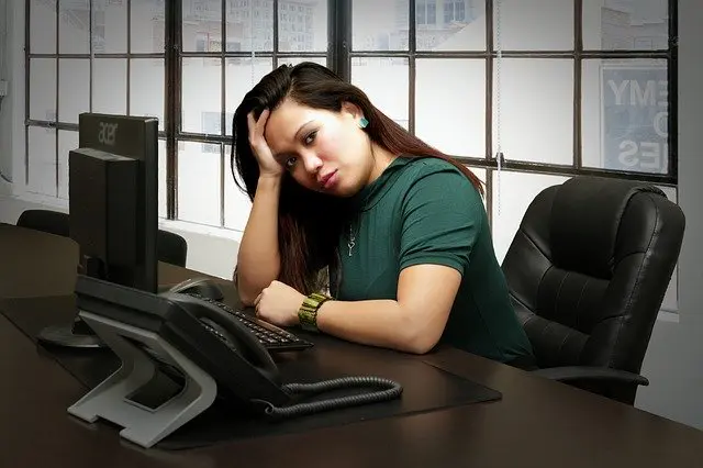 a woman sits in front of an acer computer