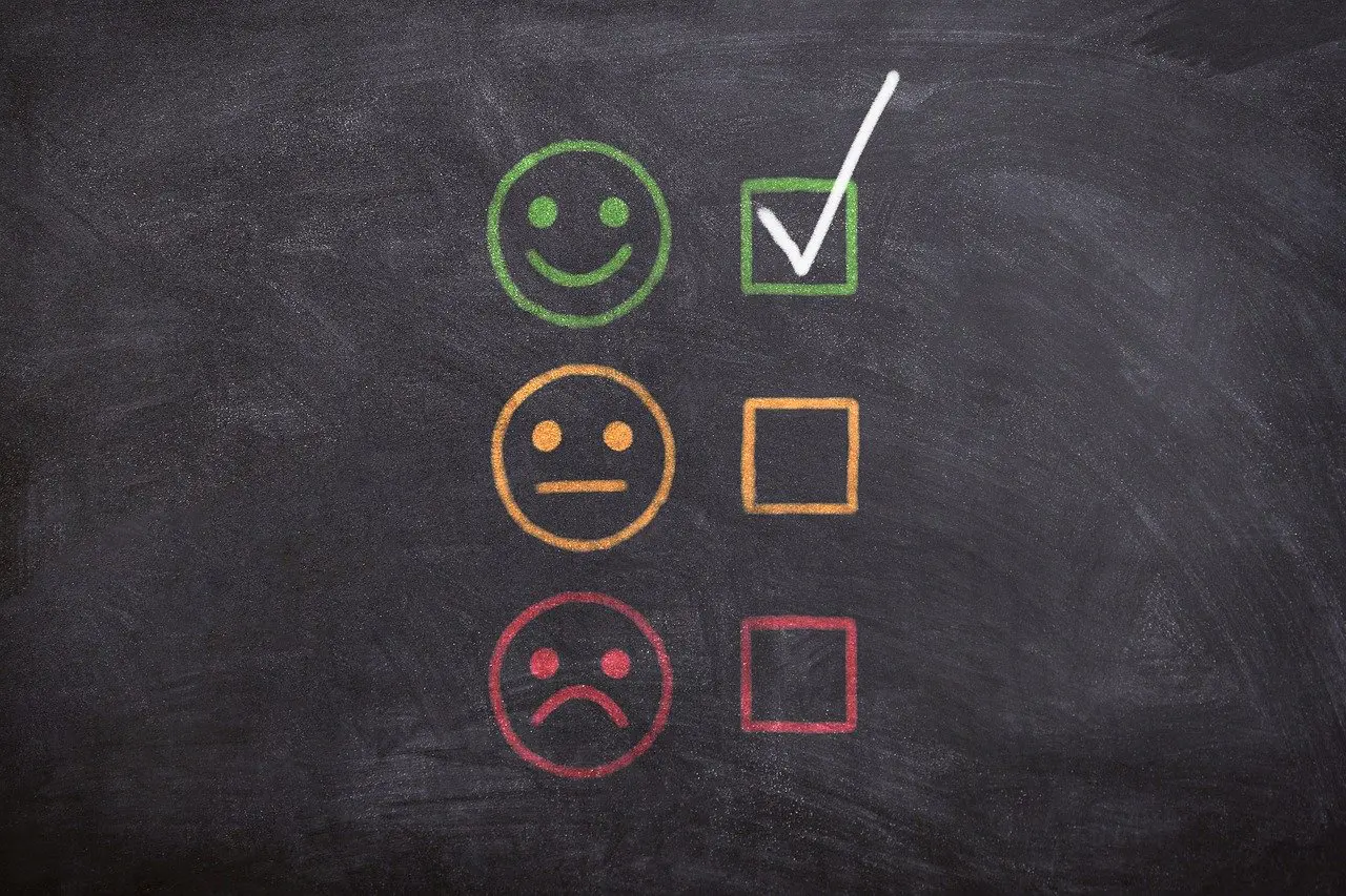 a blackboard with smiley faces and a check mark