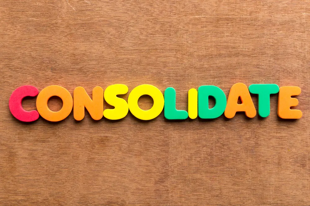 the word consolidate is written in colorful letters on a wooden surface
