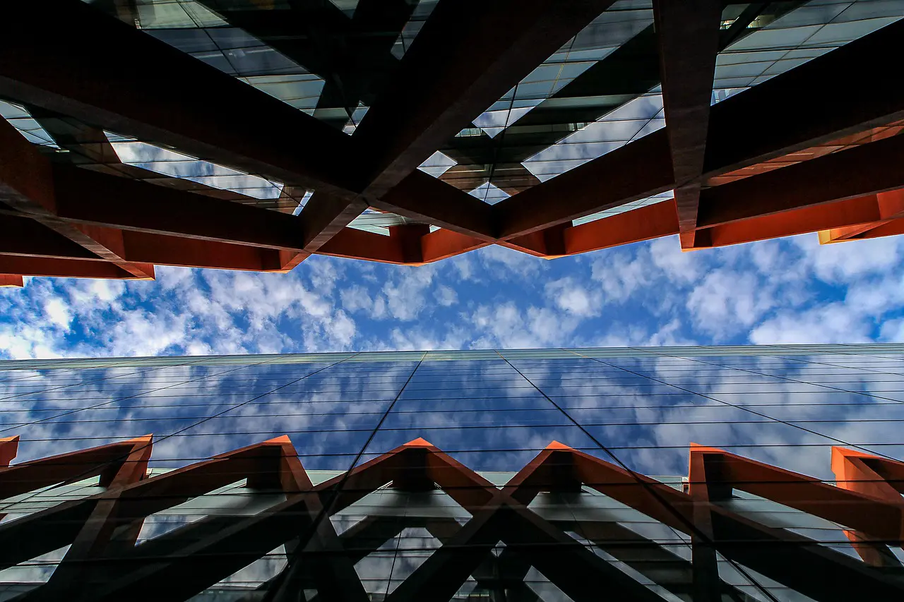 looking up at a building with a blue sky in the background