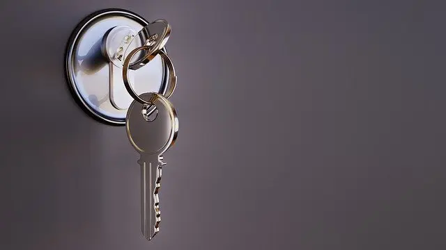 a pair of keys hanging from a lock