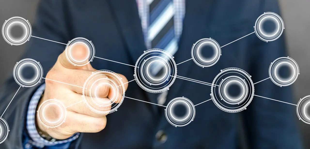 a man in a suit and tie is pointing at circles on a screen