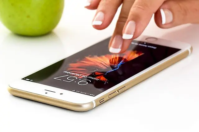 a person is touching a cell phone with their finger