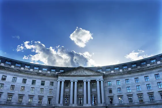 a large building with a blue sky and clouds in the background .