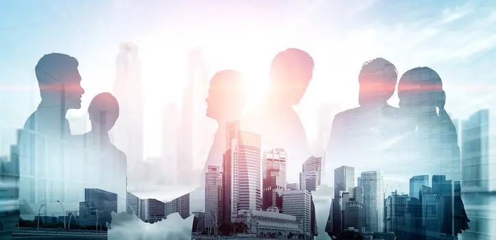 figures of several individuals interacting and holding hands with a backdrop of a city in the background