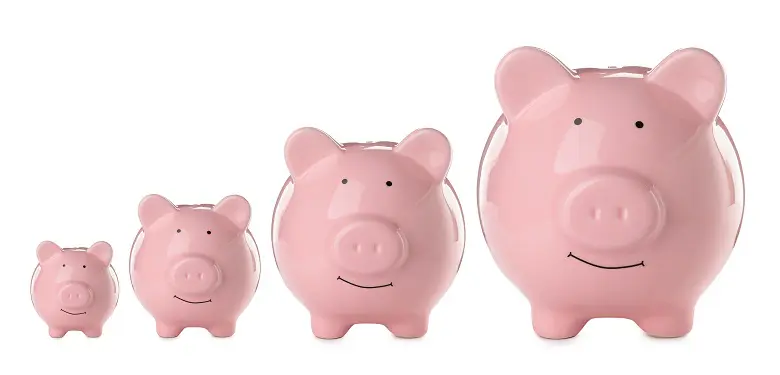 four pink piggy banks are lined up in a row on a white background