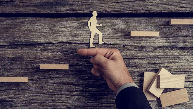 a hand points to a silhouette of a man walking up stairs