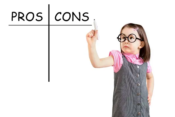 a little girl is writing pros and cons on a white board