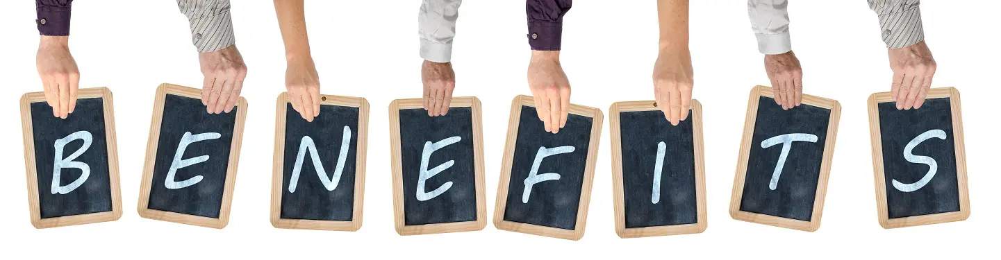 Group of people holding up chalkboards with the word benefits written on them