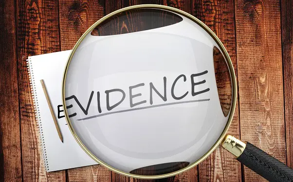 a magnifying glass is looking at a piece of paper that says evidence