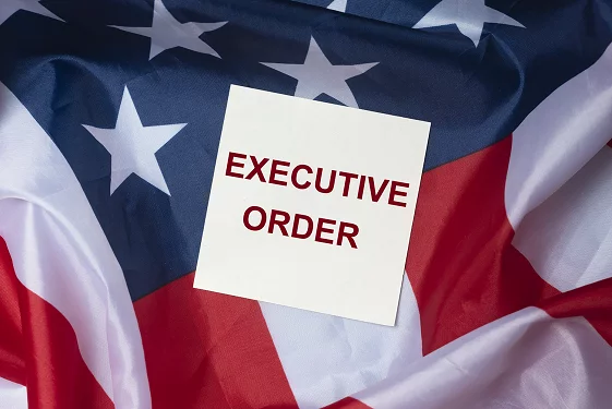 American flag with a note that says executive order on it