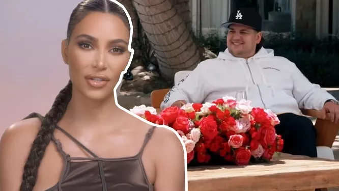 rob kardashian sits at a table with flowers with kim kardashian in front