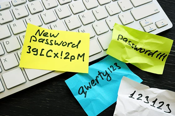 a keyboard with sticky notes on it that have passwords written on them