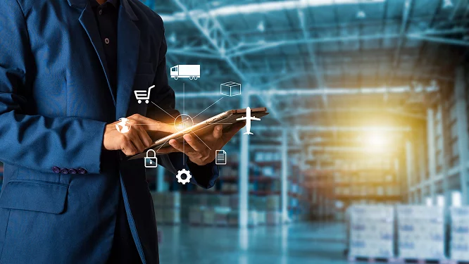 a man in a suit is using a tablet in a warehouse