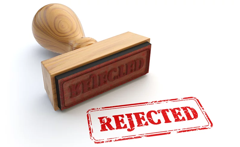 a wooden stamp that says rejected on it