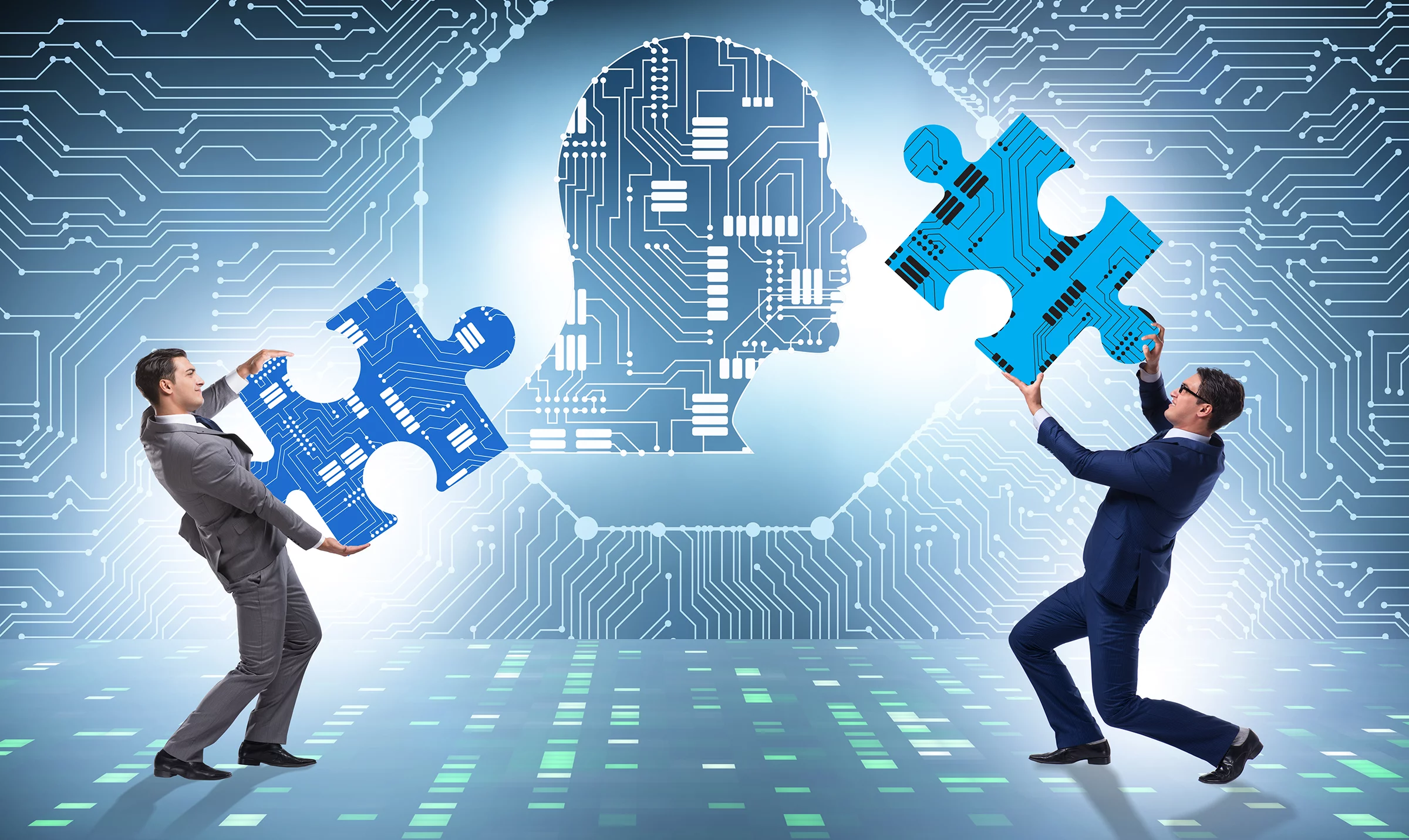 two men holding blue puzzle pieces in front of a circuit board