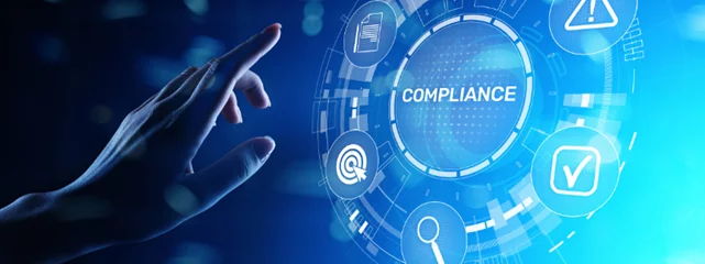a hand is pressing a button on a screen that says compliance